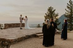 a couple getting married at the top of a mountain