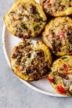 small muffins with cheese and vegetables on a white plate, ready to be eaten