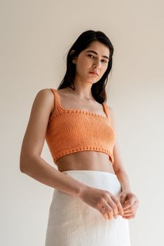 "The Square Neck Crop Top -- our iconic hand-knit cropped top is a year-round wardrobe staple. Thoughtfully designed to elevate your outfits, this versatile piece serves as the perfect blend of elegance and versatility. Handcrafted with utmost care, the Square Neck Crop Top is made from the finest blend of Oeko-Tex cotton, ensuring a luxuriously soft feel against your skin. With its square neckline, wide shoulder straps, and comfortable fit, this top flatters all silhouettes while elegantly framing your décolletage, accentuating your natural beauty with ease. Inspired by the desire for effortless style throughout the year, it can be paired with your favorite linen pants or a gathered long skirt and seamlessly take you from morning strolls to seaside dinners. Every top is made to order. To Seamless Cropped Knit Crop Top, Fitted Knitted Orange Top, Fitted Orange Knitted Tops, Cropped Knit Top For Beach, Seamless Fitted Cropped Crochet Top, Summer Cropped Knitted Tops, Summer Knitted Cropped Tops, Knitted Cropped Top For Summer, Fitted Cropped Knit Top For Beach