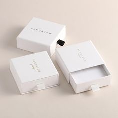 three white boxes sitting on top of each other