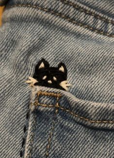 Embroidery Jean Pocket Ideas, Cat Pocket Embroidery, White Cat Embroidery, Jeans Back Pocket Embroidery, Black Jeans Embroidery Ideas, Cute Stitches On Clothes, Embroidered Jeans Diy Simple, Jean Embroidery Ideas Pockets, Black Jeans Embroidery