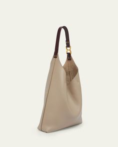 Chloe "Marcie" hobo bag in grained leather     Flat shoulder strap    Open top with center straps     Interior, one zip pocket     Approx. 9.1"H x 11.8"W x 3.5"D    Professional cleaning recommended    Made in Italy Beige Hobo Bag With Leather Handles For Work, Luxury Pebbled Leather Hobo Bag With Gold-tone Hardware, Pebbled Leather Shoulder Bag Tote With Leather Handles, Pebbled Leather Tote Shoulder Bag With Leather Handles, Calf Leather Tote Shoulder Bag With Adjustable Strap, Luxury Hobo Bag With Adjustable Strap For Everyday, Everyday Pebbled Leather Shoulder Bag With Leather Lining, Chic Calf Leather Hobo Bag With Adjustable Strap, Pebbled Leather Shoulder Bag With Double Leather Handles