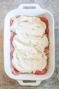 a casserole dish filled with meat and cream