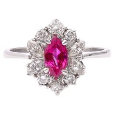 One Vintage Ruby Diamond 18k White Gold Cluster Ring. Featuring one marquise cut ruby weighing approximately 0.55 carat. Accented by six round brilliant and four marquise cut diamonds with a total weight of approximately 0.25 carat, graded near-colorless, SI clarity. Crafted in 18 karat white gold with purity mark. Circa 1990. The ring is a size 6 ¼ and may be resized. About this Item: Transport yourself to the glamorous era of the 1990s with this stunning vintage ruby and diamond cluster ring. Luxury Marquise Ruby Ring With Diamonds, Classic Marquise Ruby Ring With Brilliant Cut, Elegant Marquise Ruby Ring With Vvs Clarity, Classic Marquise Ruby Ring With Vvs Clarity, Elegant Marquise Ruby Ring With Halo Setting, Marquise Ruby Ring With Diamonds, Ruby Rings With Marquise Cut In Halo Setting, Ruby Rings With Halo Setting And Marquise Cut, Marquise Red Diamond Ring