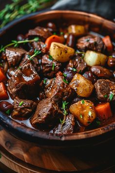 Beef stew with chunks of beef, potatoes, carrots, and herbs in a wooden bowl. Beef Bourguignon Julia Child Recipe, Hearty Beef Recipes, Red Wine Soup Recipes, Healthy Hearty Recipes, Hearty Beef Soup Recipes, Classic Beef Bourguignon, Beef Wine Recipes, Friends Dinner Recipes, September Crockpot Meals