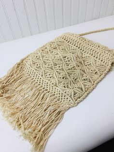 "Vintage macrame purse. Wonderful hippie boho style. This is really from the 1970s, perfect for the vintage lover! Very clean. Size is : 15\" long with fringe x 10\" wide. Total length with strap is 30\"." Vintage Crossbody Shoulder Bag For Beach, Bohemian Fringe Rectangular Hobo Bag, Hippie Handwoven Shoulder Bag For Festivals, Vintage Handwoven Natural Shoulder Bag, Hippie Festival Handwoven Shoulder Bag, Bohemian Cream Crochet Crossbody Bag, Vintage Woven Shoulder Bag For Vacation, Bohemian Beige Bag With Fringe, Bohemian Beige Braided Beach Bag