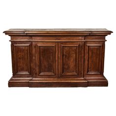 an old wooden cabinet with marble top