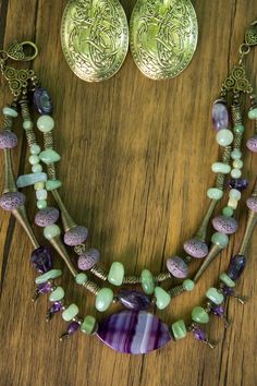 a necklace and earring set on a wooden table