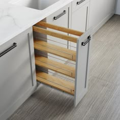 an open cabinet in the middle of a kitchen