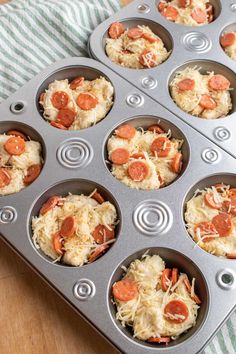 a muffin tin filled with cupcakes covered in cheese and pepperoni slices