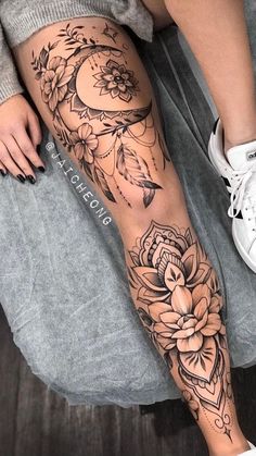 a woman's leg with tattoos and flowers on it