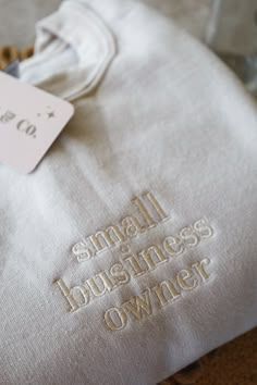 small business owner embroidered on the back of a white shirt