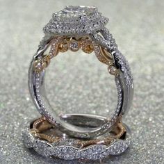 an image of two wedding rings with diamonds on the top and bottom, set in gold and silver