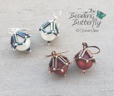 three different sized earrings are shown on the ground with beads attached to each earring