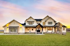 a large white house sitting on top of a lush green field