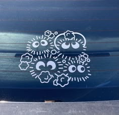 two stickers on the side of a car that have been decorated with sheep and clouds