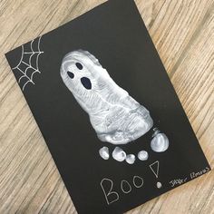 a halloween card with a ghost and pumpkins on it, which reads booy