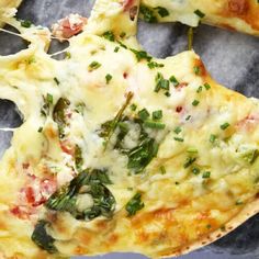 two pieces of pizza with spinach and cheese