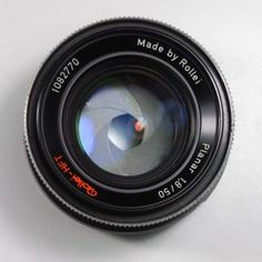 a camera lens sitting on top of a white table