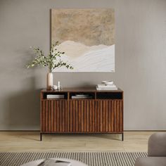 a living room scene with focus on the sideboard and painting in the background,