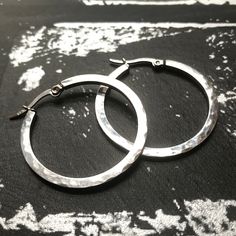 Crafted from durable 316L stainless steel, these medium-sized hand hammered hoop earrings are perfect for all occasions. Unlike sterling silver, they will NEVER TARNISH OR LOSE THEIR SHINE and are 100% waterproof. Stainless is also a great alternative for those with sensitive skin. Each polished hoop measures 1.4 inches in diameter (35mm) and closes securely with a hinge lock clasp. Bonus: these earrings come in a charming jewelry box with a soft black velvet lining - making them a fabulous gift Nickel-free Small Hoop Stainless Steel Earrings, Nickel-free Stainless Steel Small Hoop Earrings, Nickel-free Small Stainless Steel Hoop Earrings, Small Stainless Steel Nickel-free Hoop Earrings, Hypoallergenic Silver Stainless Steel Hoop Earrings, Silver Hammered Hoop Earrings For Everyday, Modern Silver Hammered Hoop Earrings, Everyday Silver Hammered Hoop Earrings, Everyday Hammered Metal Hoop Earrings