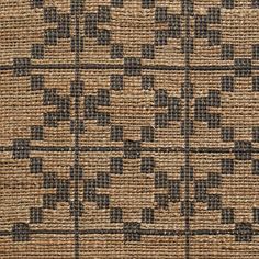 a close up view of an area rug with black and tan designs