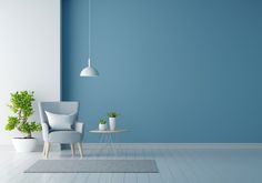 an empty room with blue walls and white furniture