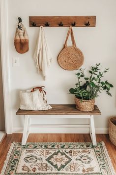 a wooden bench sitting in front of a white wall next to a potted plant