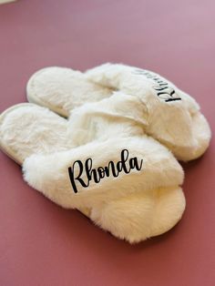 "**Slippers**  Made of soft faux rabbit fur, premium cotton, and memory foam - making them warm, comfortable, and skin-friendly. They also have a non-slip sole.  1. Select Primary Color and Size (listed in women's US sizes) 2. Select Font Color (colors in picture do not reflect actual color, message me if needing to see a specific color or request a different color that is not listed) 4. Add Personalization Bulk order discount is available for 5 or more orders Message me for details ✏️ ALSO OPTIONAL :: include a personal message to the recipient on a card - write your message in the \"add personalization\" section Consider adding a robe to your order to make a set :: https://www.etsy.com/listing/1403097079/personalized-silk-robe-set-furry-house?click_key=1e1d5cc0cebdc3e5c0fda2be6ce0e87dbe7 Comfortable Fluffy White Slippers, White Fluffy Indoor Slippers, Fluffy White Indoor Slippers, Cozy White Slippers With Plush Lining, Slippers Wedding, Personalized Slippers, Wedding Slippers, Handmade Slippers, Ear Tag