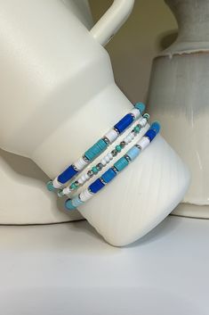 A beachy collection of blue and turquoise beaded bracelets hand crafted to add personal style to your Stanley cup.  🌟 Great for gift giving, holidays, sports, parties, and everyday charm. 🌟 Set includes 3 bracelets designed to fit the 40oz Stanley Quencher with a silicone boot in place.  🌟Variation https://tinebirddesigns.etsy.com/listing/1738326186 Tips & Care: - Will also fit the 20oz and 30oz Stanley cups with a silicone boot (not included) - Remove bracelets prior to washing tumbler. Not Turquoise Friendship Bracelets As Beach Season Gifts, Blue Beachy Friendship Bracelet, Turquoise Beaded Bracelets For Beach Season Gift, Turquoise Beaded Bracelet For Beach Season Gift, Blue Strand Friendship Bracelets In Beachy Style, Blue Strand Friendship Bracelets For Beach Season, Turquoise Strand Friendship Bracelets, Blue Strand Friendship Bracelets Beachy Style, Handmade Blue Strand Friendship Bracelets