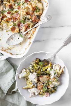 a casserole dish with chicken, broccoli and cheese in it next to a serving spoon