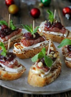 small appetizers are arranged on a silver plate