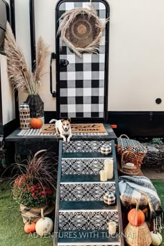 a dog is sitting on the steps in front of a camper