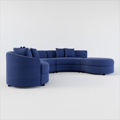 a large blue sectional couch with pillows on it's back and side facing the camera