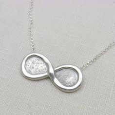 "Custom Personalized Silver Fingerprint Infinity Necklace or Pendant - This beautiful necklace is personalized with your ACTUAL fingerprints and is a beautiful wedding gift, anniversary gift, best friend gift, Mother's Day gift, and more! Handmade using fine silver, the pendant measures approx. 5/8\" x 1-3/8\" and hangs on a sterling silver rolo chain that closes with a silver lobster clasp. I will add a small layer to the back with a date or initials, which is textured with tiny hearts. If you Customizable Sterling Silver Necklaces For Formal Occasions, Customizable Sterling Silver Necklace For Formal Occasions, Elegant Customized Necklaces For Anniversary Gift, Elegant Customized Necklace For Anniversary Gift, Customized White Gold Necklace For Anniversary, Customized Sterling Silver Necklace For Wedding, Elegant Custom Necklace For Mother's Day Anniversary, Elegant Custom Necklace For Anniversary And Mother's Day, Custom Sterling Silver Necklace For Wedding