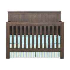 a wooden crib with blue and green striped bedding on the bottom half, against a white background