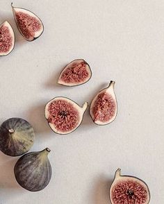 figs cut in half on a white surface