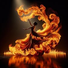 a woman is dancing with fire in her dress