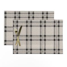 two place mats with gold forks and knife on top of each other, both in plaid pattern