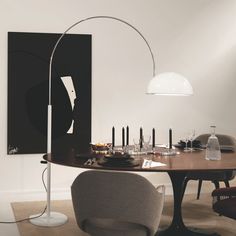 a dining room table with chairs and a lamp