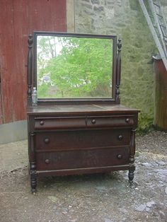 an old dresser with a mirror on top