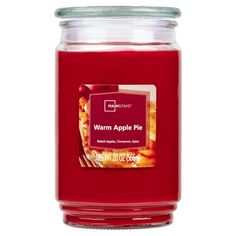 a red jar filled with warm apples and cinnamons on top of a white background