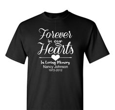 This unisex Memorial T-shirt is crafted with premium cotton for a lasting, comfortable fit. Featuring a heartfelt design with "Forever in our Hearts" on the back, it's a warm and touching symbol to honor a lost loved one. This "Forever in our Hearts" Memorial T-shirt with a name and a date is a beautiful way to keep that person gone to soon close to your heart at all times. Say it proudly with this made to order garment. Personalization comes at no extra charge. Shown in black and Navy Blue SHIR Memorial Shirts In Loving Memory Dad, In Memory Tshirt Designs, In Loving Memory Tshirt Design, In Loving Memory Shirt, In Loving Memory T Shirts Ideas, R I P Shirts Ideas, Black Heart-shaped Graphic Tee, Memorial T Shirts Ideas Design, Memorial Tshirt Ideas With Picture