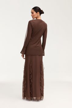 Indulge in the exquisite elegance of the Adriana Waterfall Mesh Maxi Skirt in Brown. Crafted from delicate mesh fabric, this skirt features a cascading waterfall ruffle detail and flattering princess seams. Perfect for making a sophisticated statement at any event or occasion. Model is 5'7" and is wearing size S/44". Please note this garment runs tight. We kindly recommend choosing one size up from your usual size. Elegant Party Skirt With Layered Hem, Elegant Fitted Skirt With Layered Hem, Elegant Skirt With Ruffles, Elegant Party Skirt With Ruffle Hem, Elegant Fitted Maxi Skirt With Layered Hem, Elegant Sheer Chiffon Skirt, Evening Maxi Tiered Skirt With Ruffles, Evening Tiered Maxi Skirt With Ruffles, Evening Tiered Ruffle Maxi Skirt