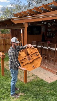 a man is holding a large piece of furniture