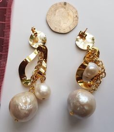 These beautiful earrings are designed with one large 18mm and a smaller 10mm baroque pearl beads. It is one of the features of this unique and limited design. The gold adds class,makes a statement and is stunning! Fresh water pearls symbolize purity, harmony and humility. Pearls are organic gems that grow within clams and other mollusks. Fresh water pearls are formed when a foreign object acts as an irritant inside the shell. Pearls are the birthstone for the month of June. Handmade Elegant Gold Plated Pearl Earrings, Elegant Handmade Gold Plated Pearl Earrings, Formal Handmade Earrings With Baroque Pearl, Handmade Baroque Pearl Earrings For Formal Occasions, Formal Handmade Baroque Pearl Earrings, Handmade Gold Pearl Earrings For Party, Handmade Baroque Pearl Teardrop Earrings, Handmade Teardrop Baroque Pearl Earrings, Unique Gold Pearl Earrings