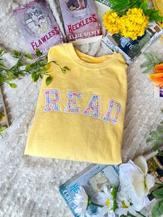 This comfy crew is perfect for spring! it features a pastel yellow Crewneck with a READ applique design using the perfect spring fabric! These sweatshirt are unisex sizing. I recommend going a size up for an oversized fit. The yellow Crewneck is Comfort Colors brand. The rest of the Crewneck option are Gildan. Oversized Yellow Spring Sweatshirt, Casual Yellow T-shirt With Embroidered Graphics, Oversized Yellow Sweatshirt For Spring, Relaxed Fit Sweatshirt With Text Print For Spring, Spring Letter Print Sweatshirt For Loungewear, Cute Oversized Spring Sweatshirt, Oversized Crew T-shirt For Spring, Yellow Oversized Sweatshirt For Loungewear, Oversized Yellow Sweatshirt For Loungewear