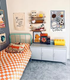 a child's bedroom with an orange and white checkered bedspread