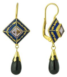 These earrings suggest the beauty and mystery of the Far East of the Mongolian hoards. A pale hand faceted amethyst is held in a diamond of deep blue enamel, from which swings a black onyx pendant. 24k gold over sterling silver setting. European backs for pierced ears. Size: 1 7/8 Inch. Elegant Enamel Dangle Jewelry, Elegant Pierced Enamel Jewelry, Black Enamel Earrings For Gift, Fine Jewelry, Black Enamel Dangle Jewelry For Formal Occasions, Formal Black Enamel Dangle Jewelry, Luxury Enamel Earrings For Gift, Elegant Enamel Dangle Earrings, Art Deco Gemstone Earrings For Gift, Elegant Enamel Drop Earrings Jewelry