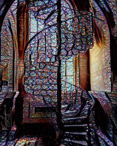 the inside of a stained glass window in a building with multiple colors and patterns on it